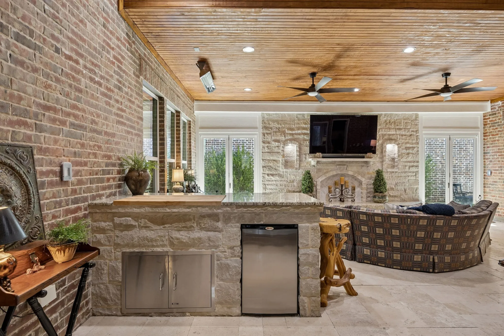 The room screams for a party.. Butcher block counter prep area, two refrigerators and  plenty of seating for the big game or movie night.