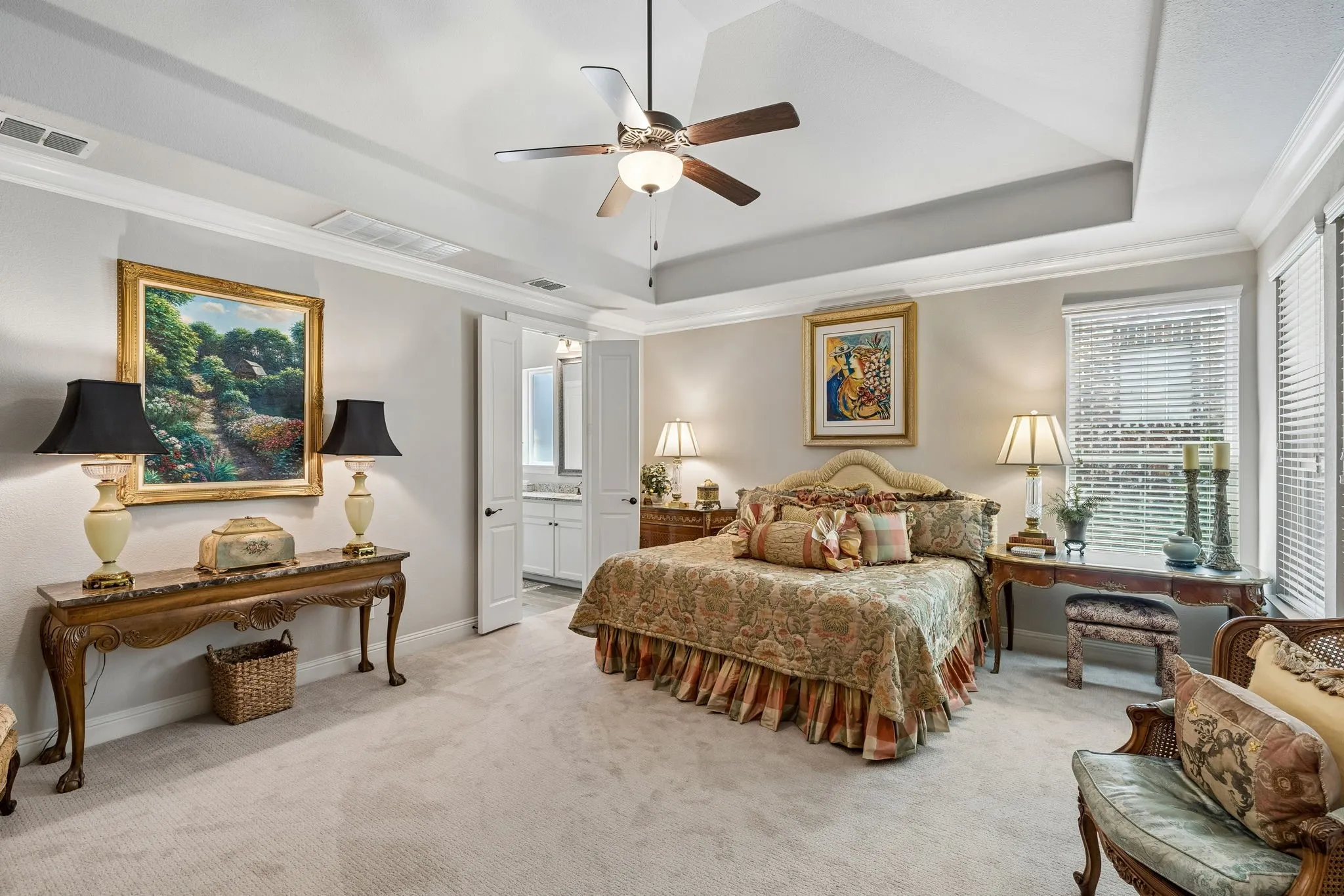 Primary suite with room for sitting area, numerous windows and tray ceiling detail.