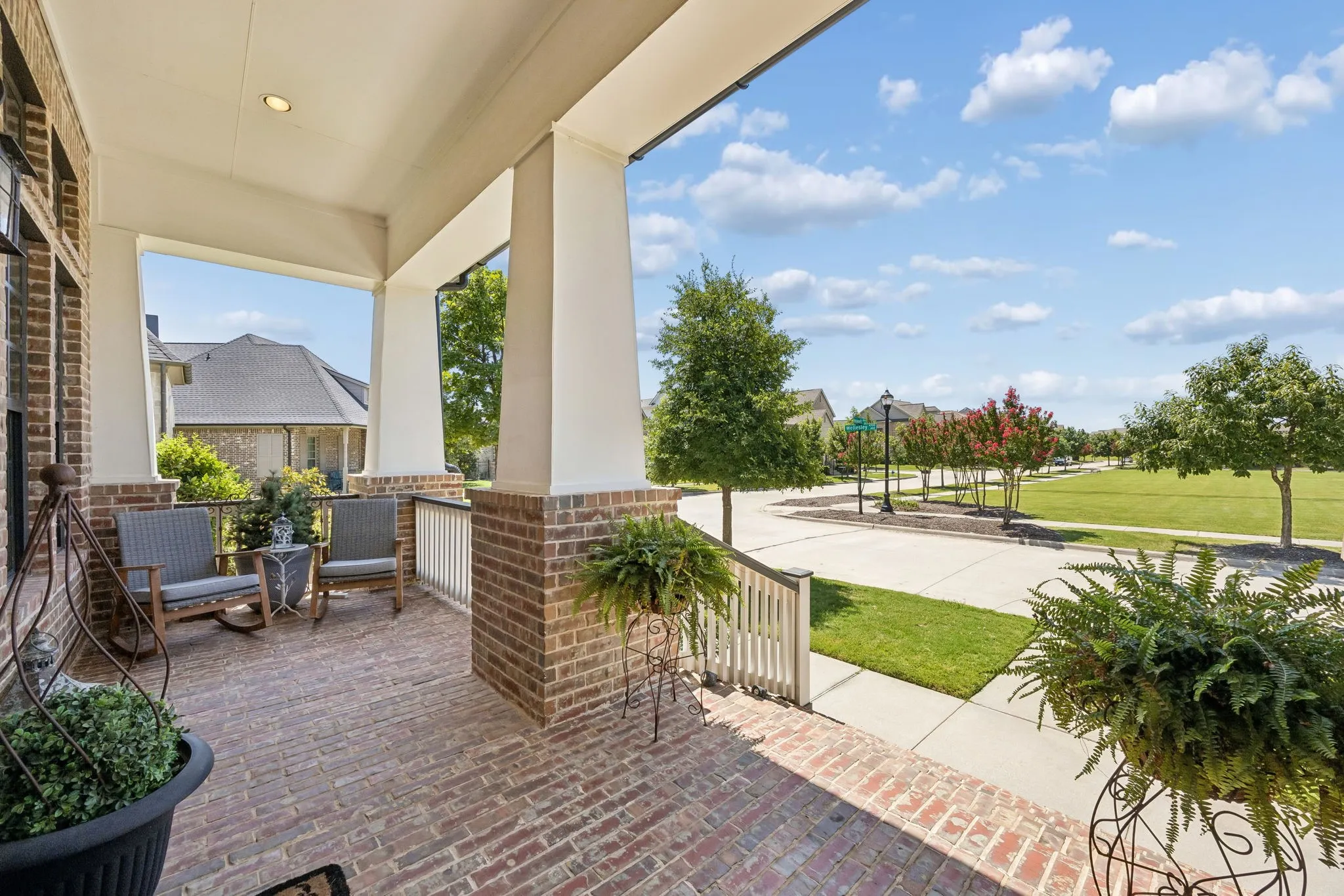 Welcoming front porch looking out to an expansive greenbelt.