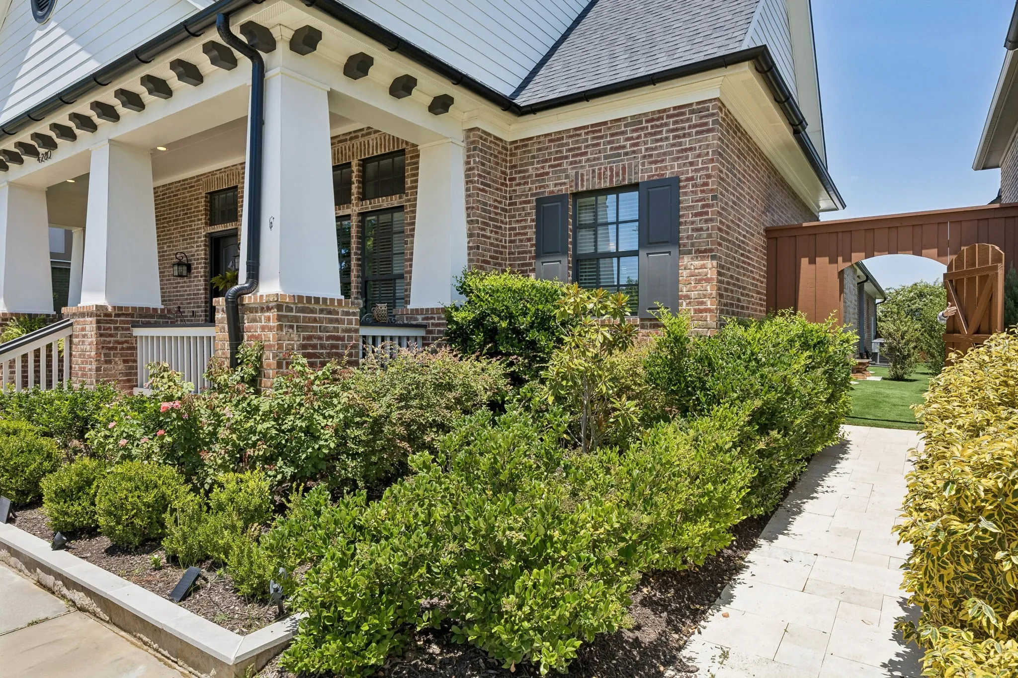 Stone sidewalk was added that leads to the side yard and den in case a guest can't maneuver the front porch steps. In addition to gorgeous landscaping.