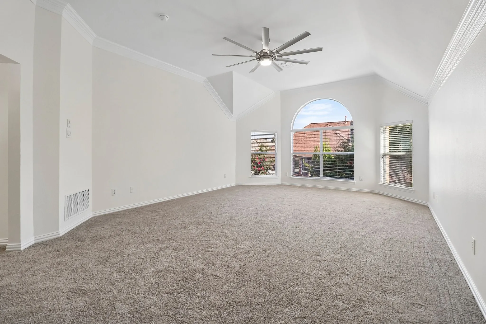Spacious game room with vaulted ceilings, triple staged crown molding, plush new carpet and lots of natural lights.