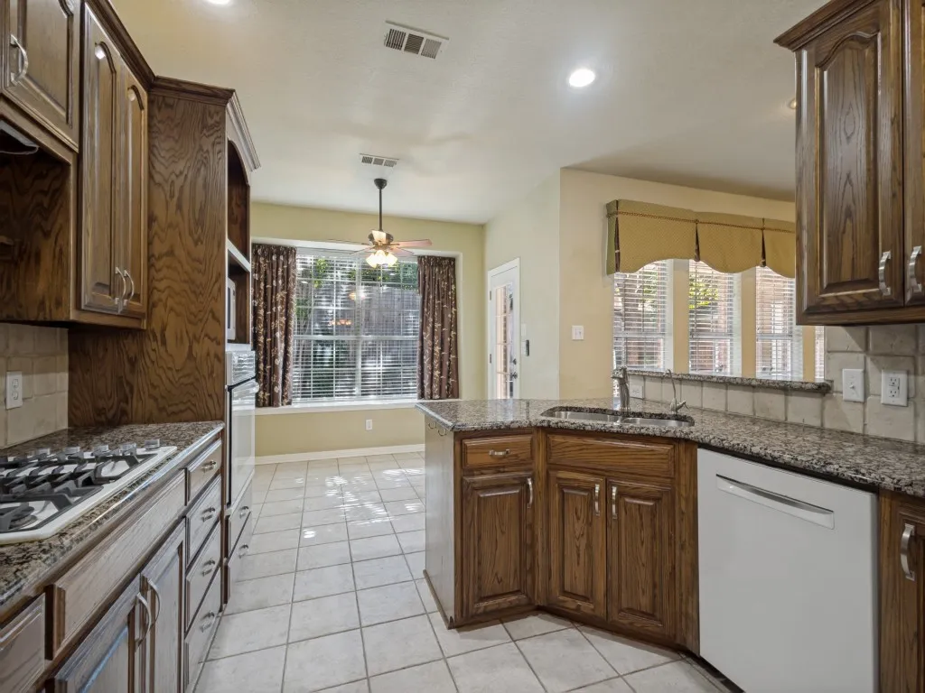 The kitchen opens into the breakfast nook and living room.