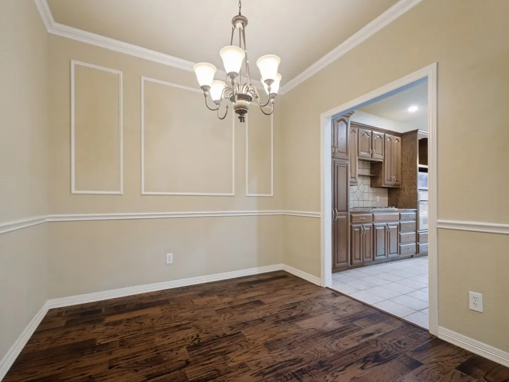 The dining room has extra touches such as crown molding, a chair rail and picture frame molding.