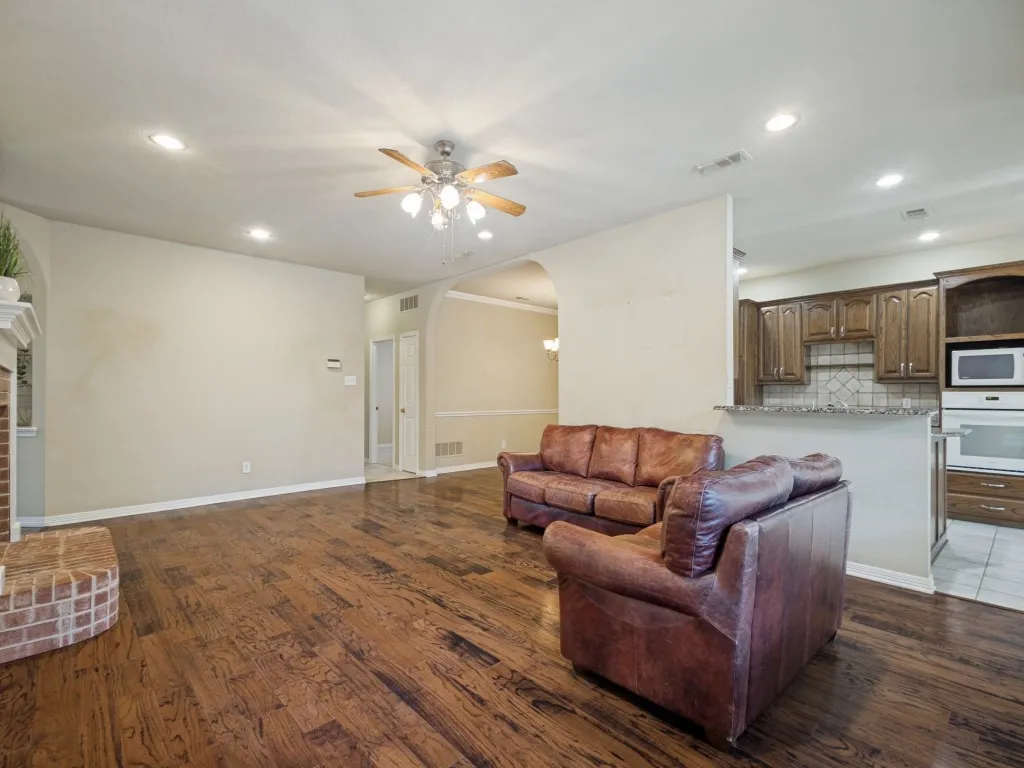 The hallway off the living room leads to two guest bedrooms, a bathroom, the laundry closet, a linen closet, and the garage.