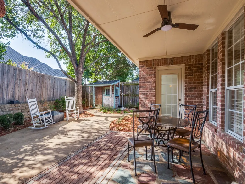 The patio offers a covered patio area with ceiling fan as well as open patio seating. Multiple places to sit and enjoy your morning coffee or spend an evening with family and friends. Doorway straight ahead leads into the primary bedroom.