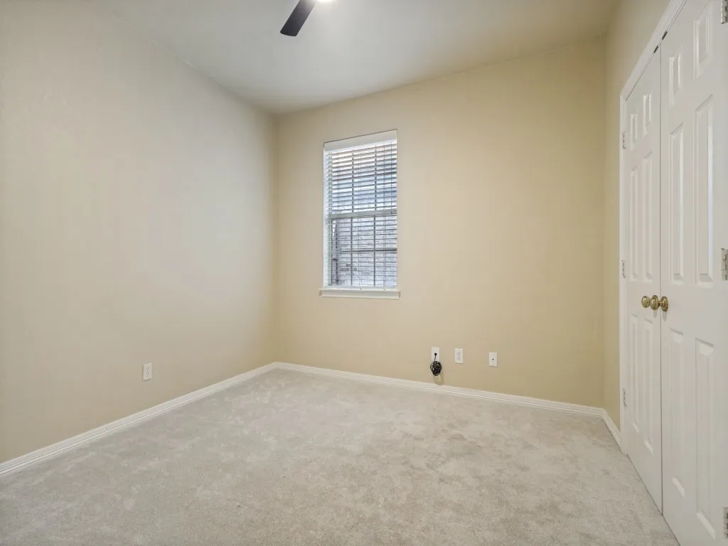 Bedroom 2 has a large closet and ceiling fan. Double doors at the closet make it so much easier to see and use everything in the closet.