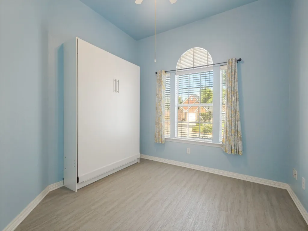 Bedroom 3 has a beautiful front-facing window, large closet, ceiling fan and a Murphy bed.