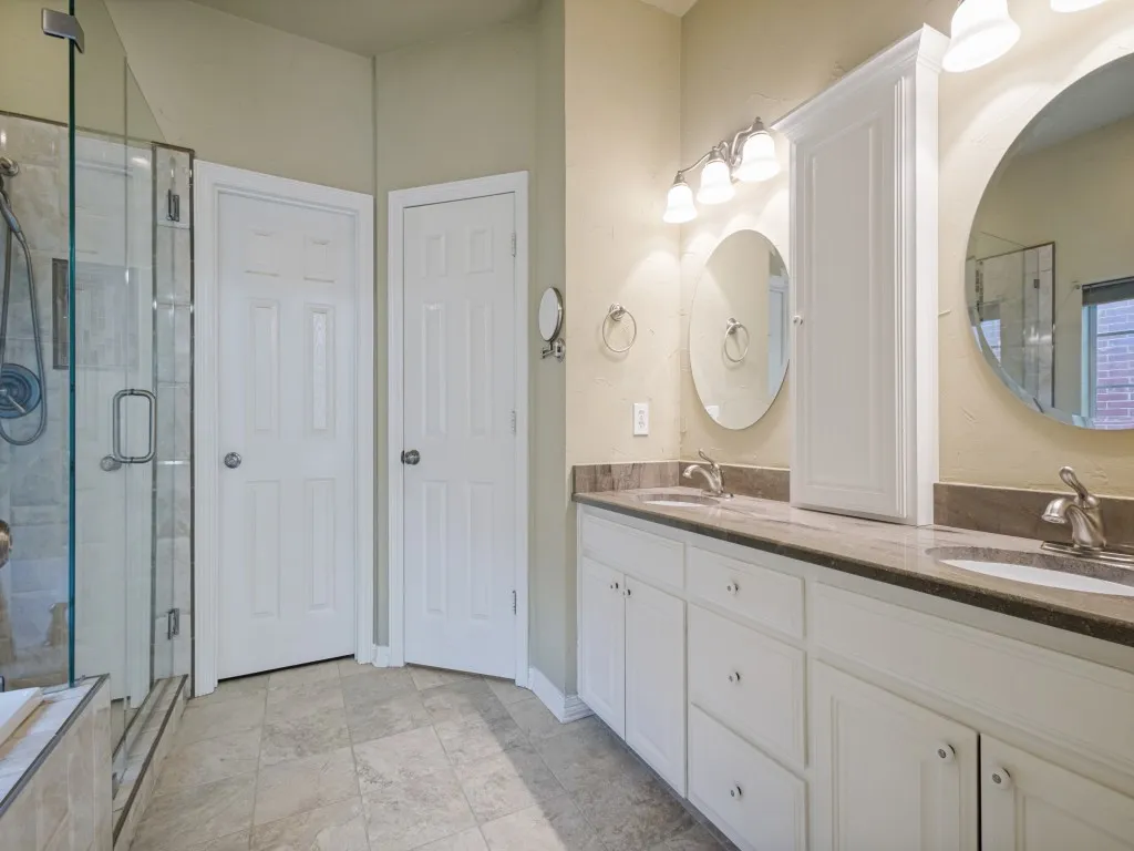 The primary bathroom has double vanities with counter top storage. Frameless glass shower, soaking tub, private toilet, and large walk-in closet.