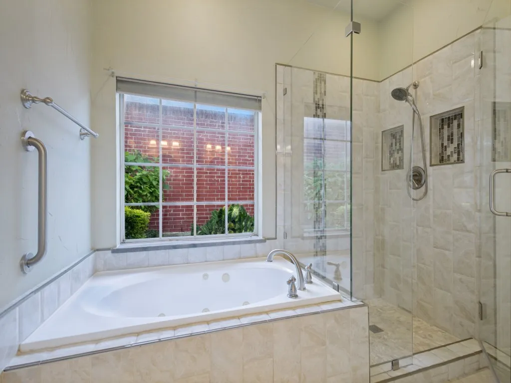 Enjoy the jetted tub and separate shower in the primary bathroom.  Special features include oversized window at the tub, frameless shower glass and accent tiles in the shower.