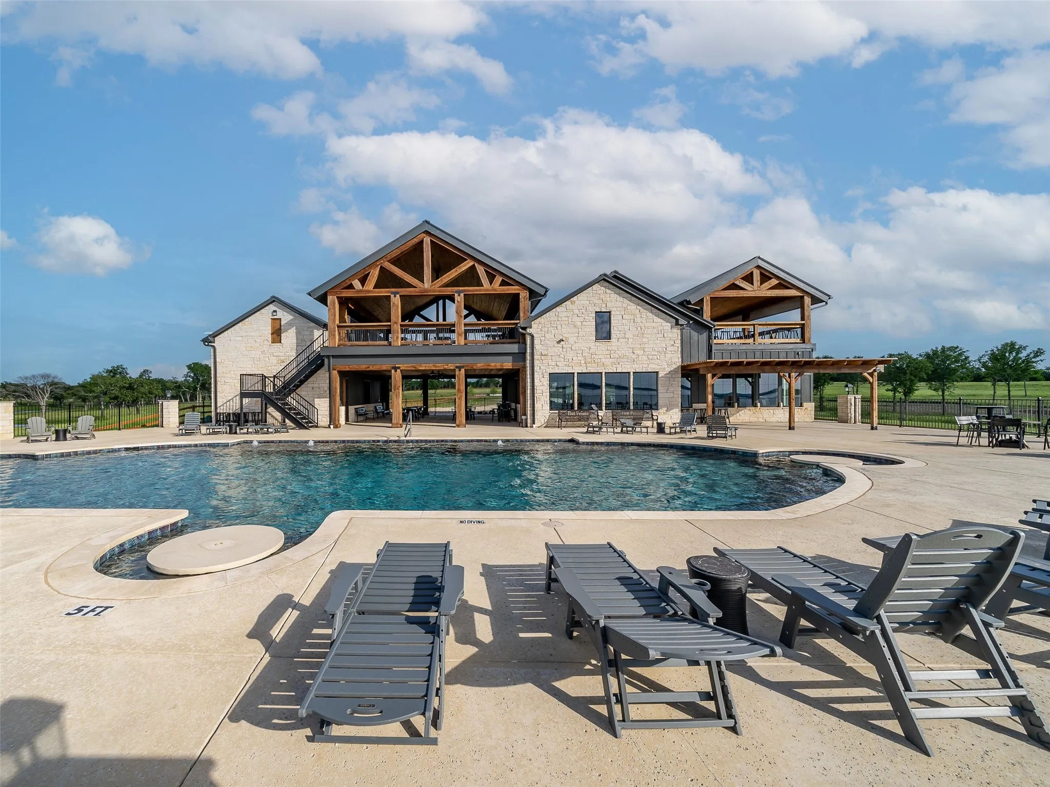 Community pool with fence, a patio area