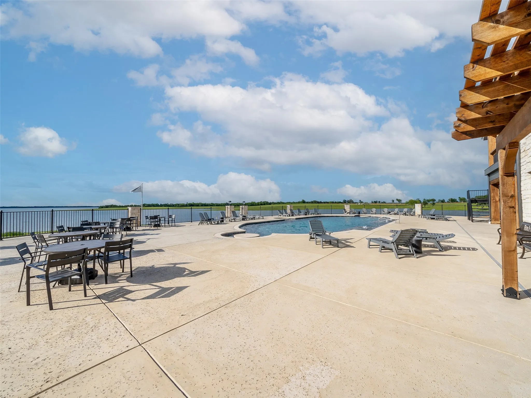 Community pool featuring a patio area, and a water view