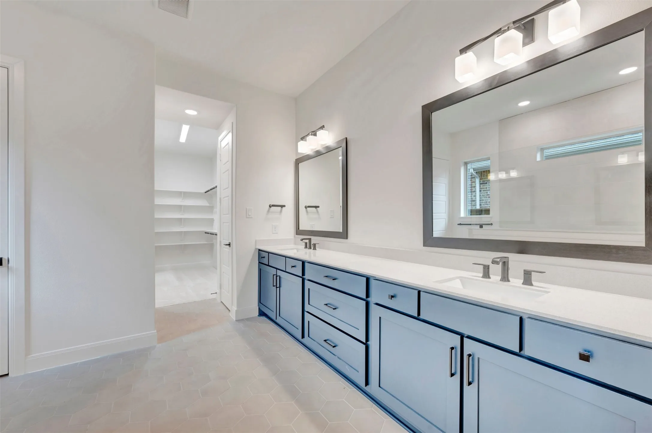 Dual vanities with undermount sinks and light blue cabinetry