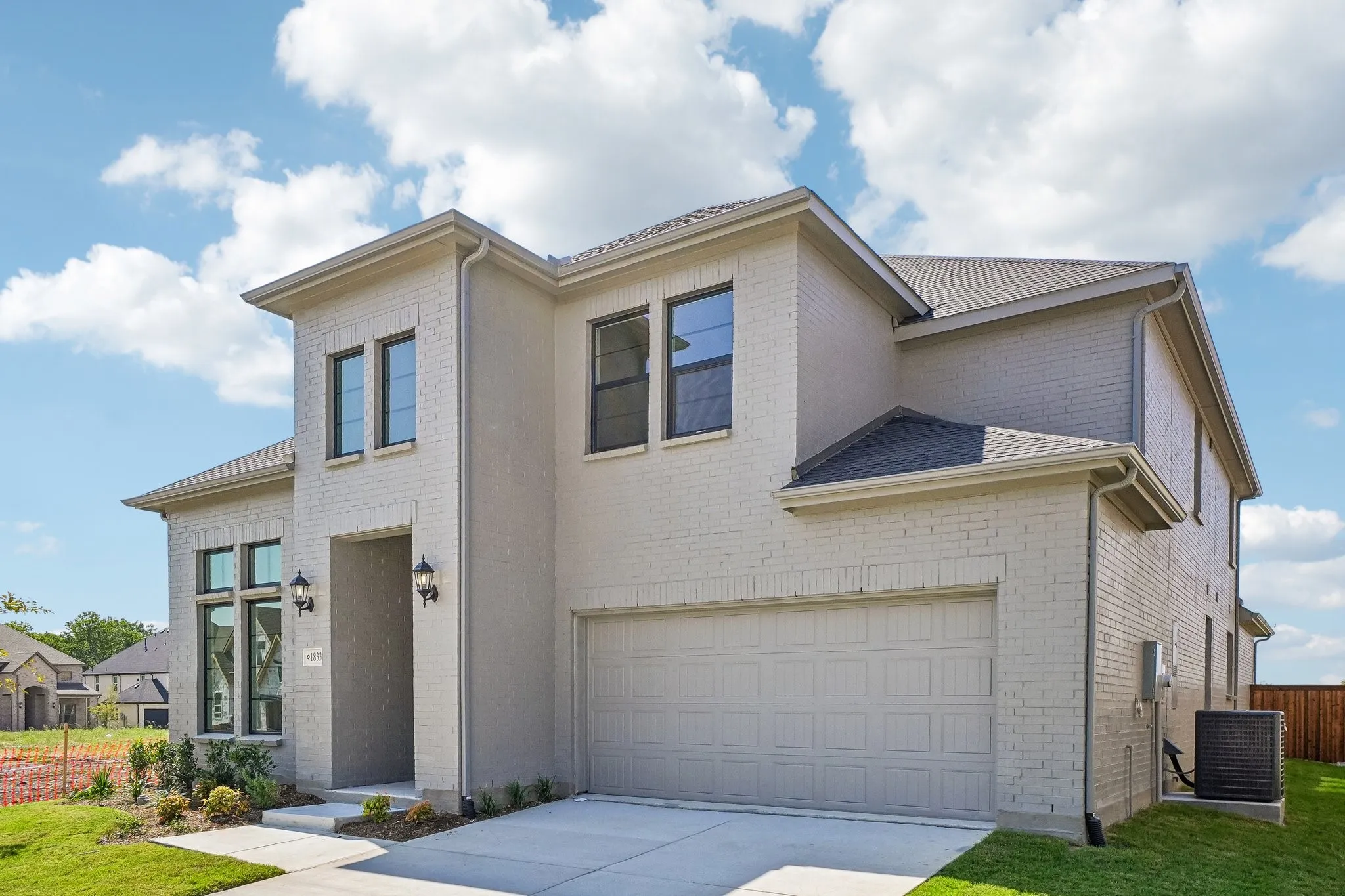 Beautiful light colored brick accented by soft, complementary colored trim create a dream home with fantastic curb appeal!