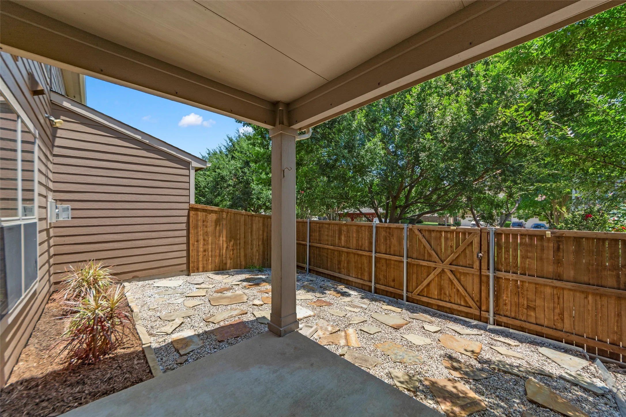 Covered patio featuring a concrete slab and stone paver accents