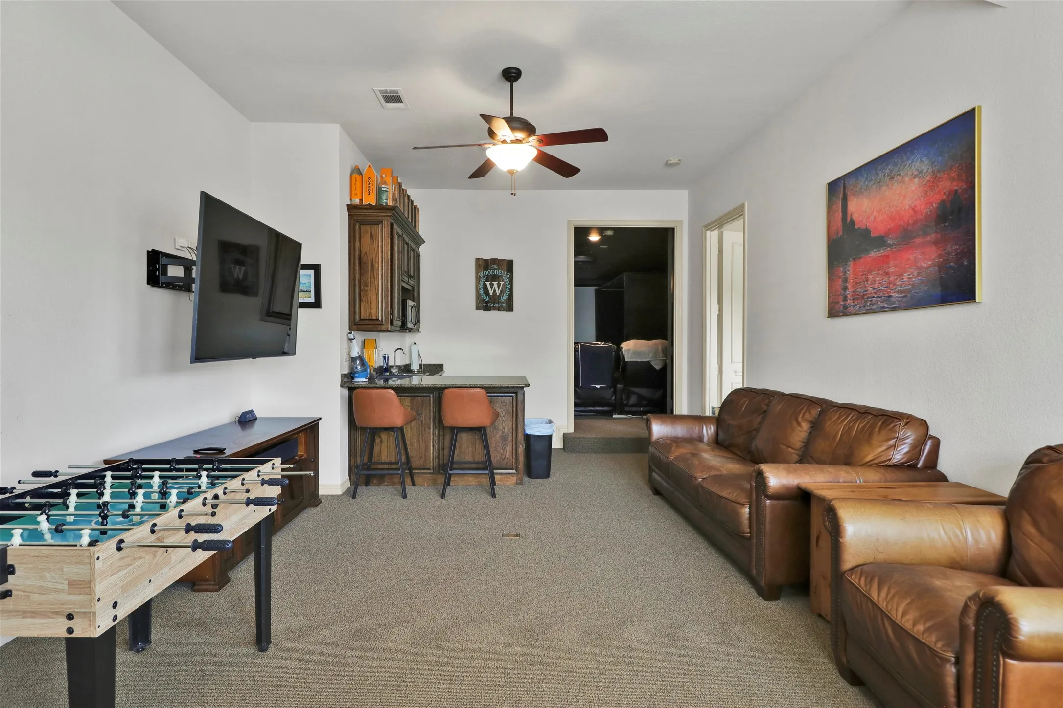 Game room upstairs with wet bar.