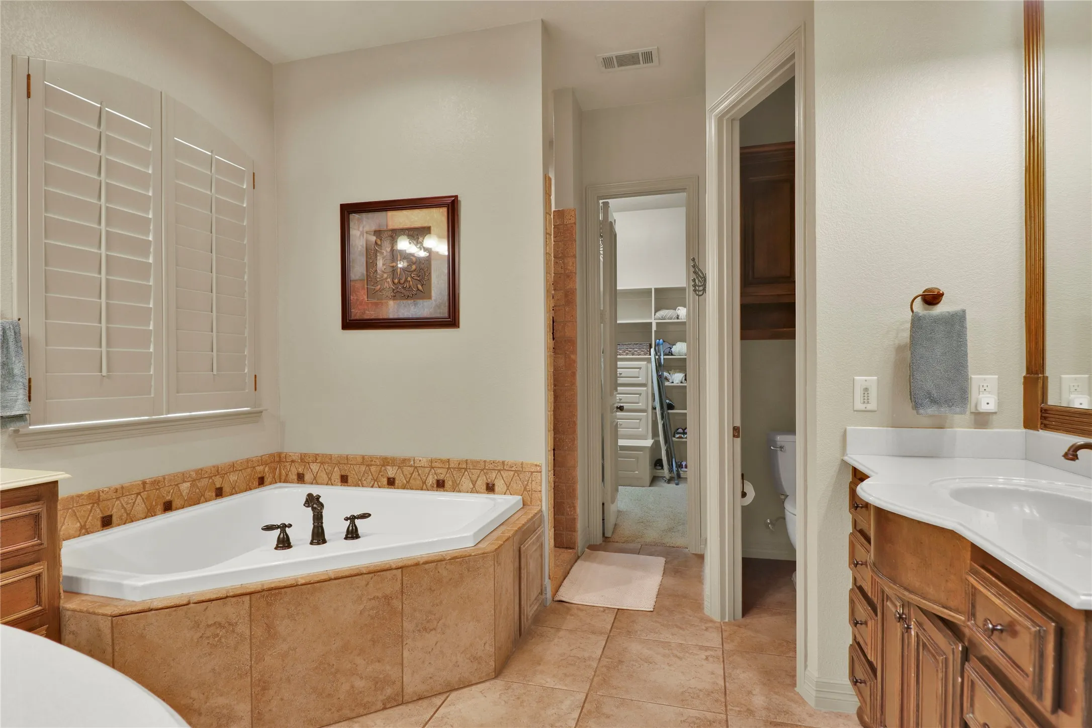 Master bath with dual vanities and garden tub.
