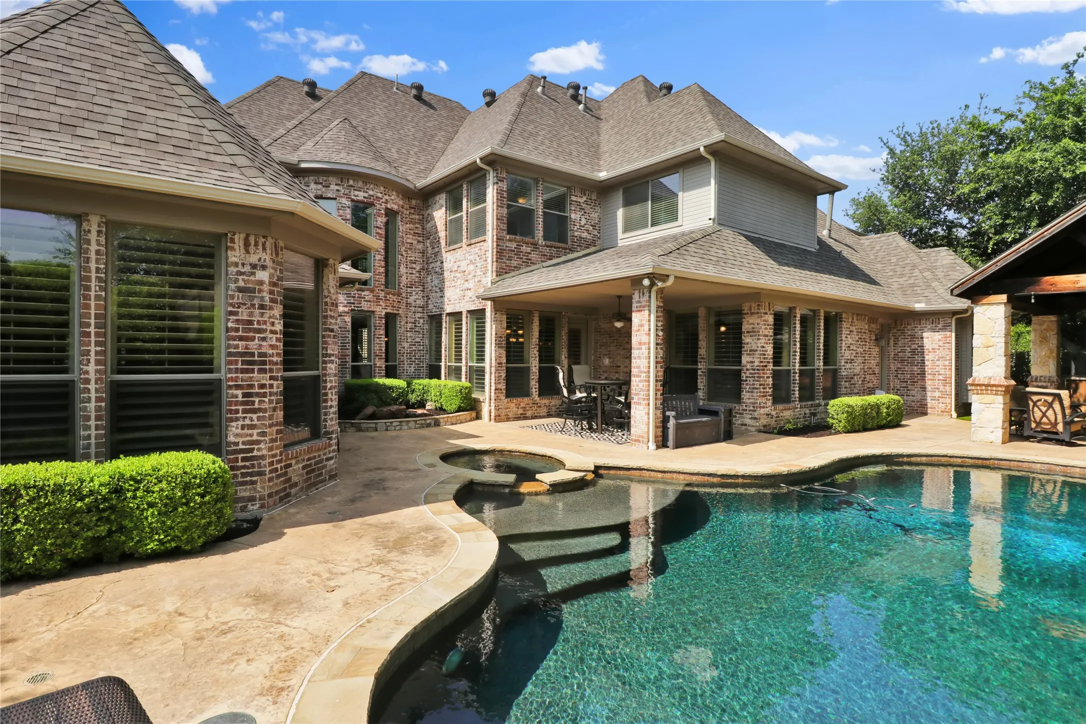 Covered patio and pool entry.