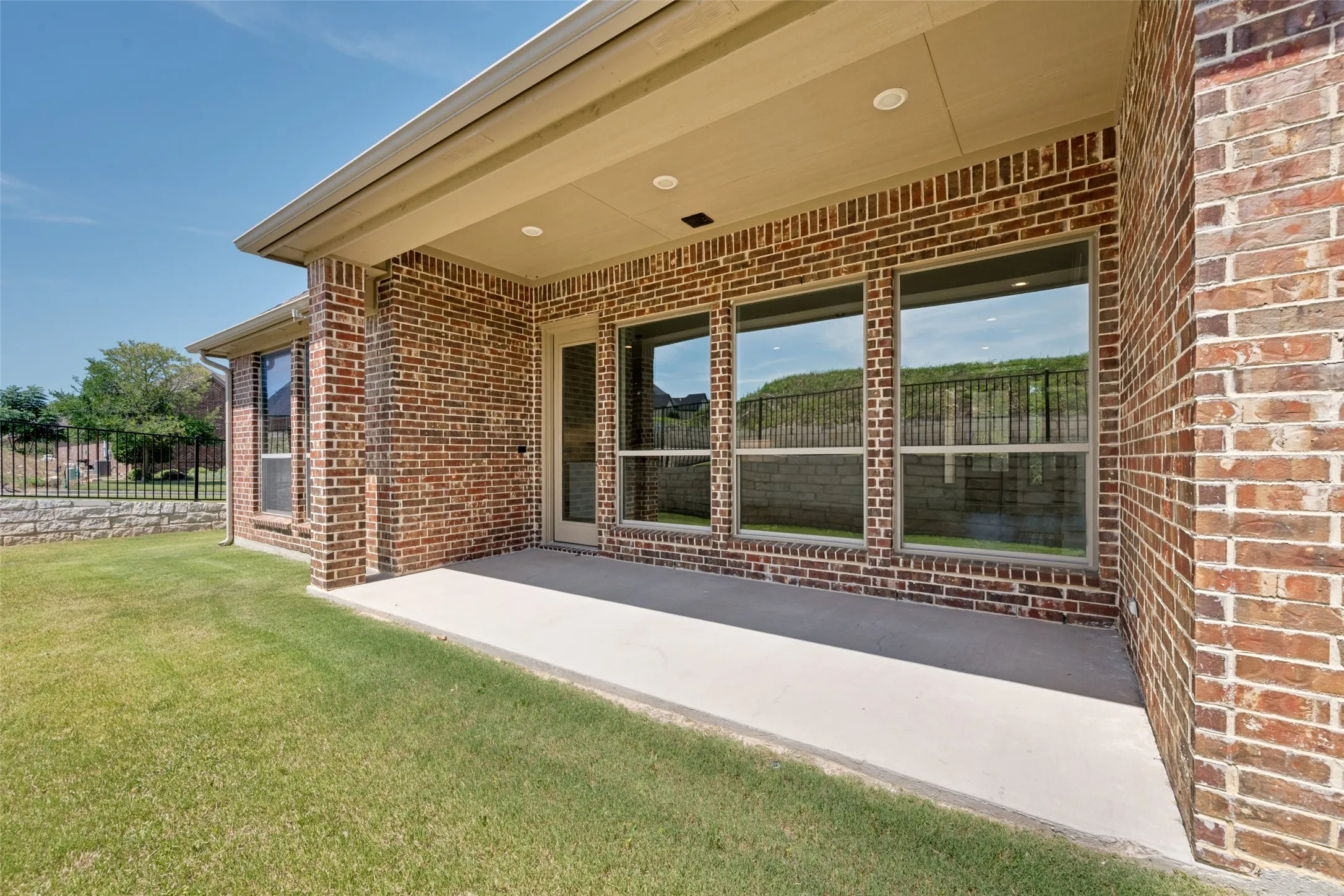 Covered patio featuring recessed lighting and brick exterior