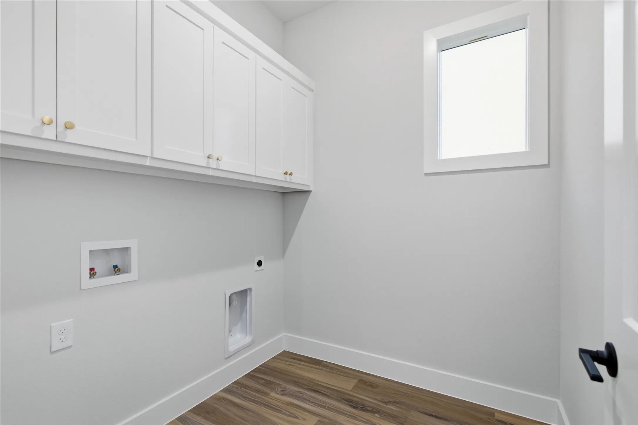White shaker-style cabinetry with gold-tone hardware