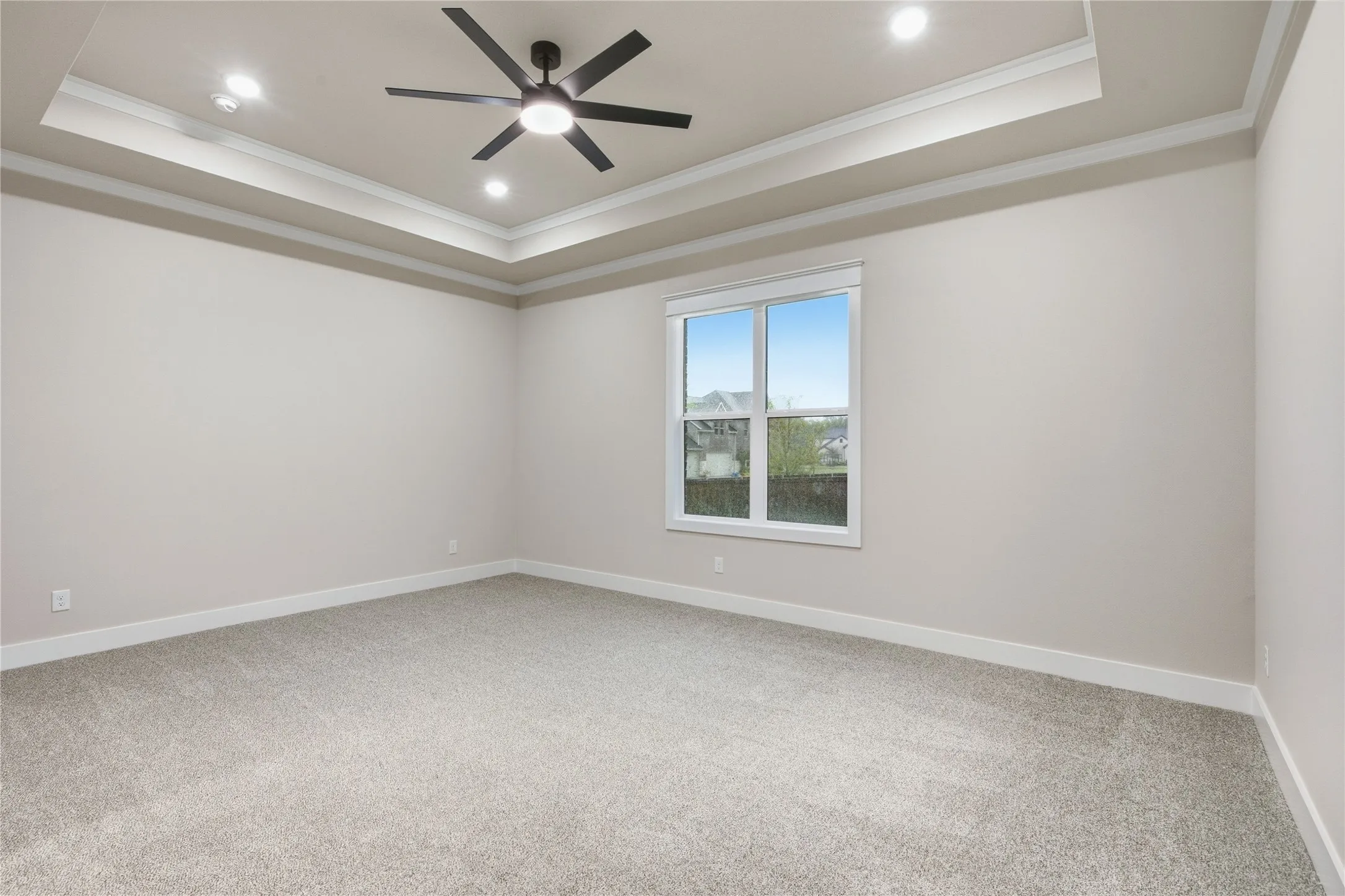 Tray ceiling with recessed lighting and crown molding