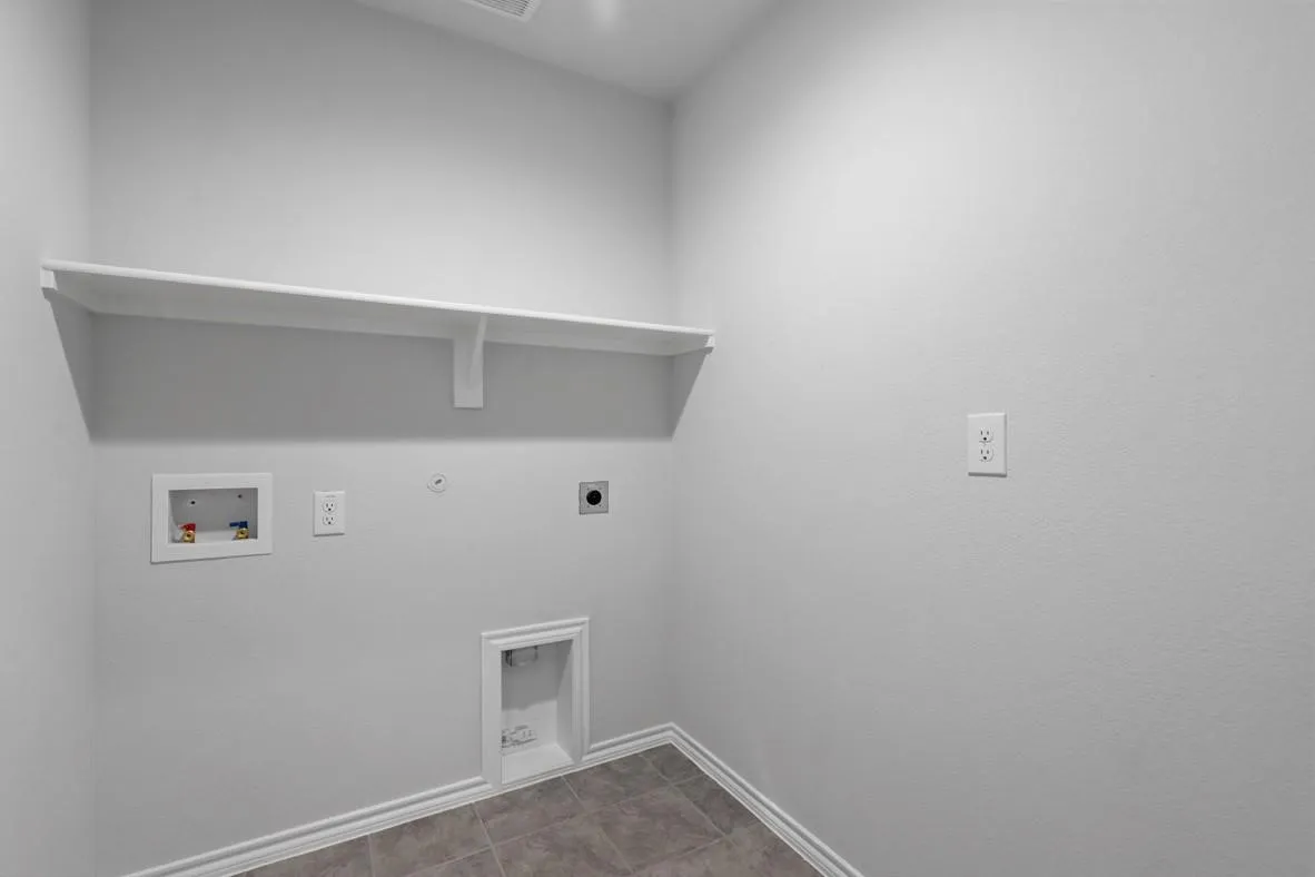 Dedicated laundry area featuring a wall-mounted shelf, appliance hookups, and ceramic tile flooring