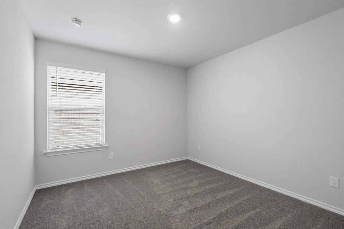 Room featuring neutral gray walls and gray carpet flooring