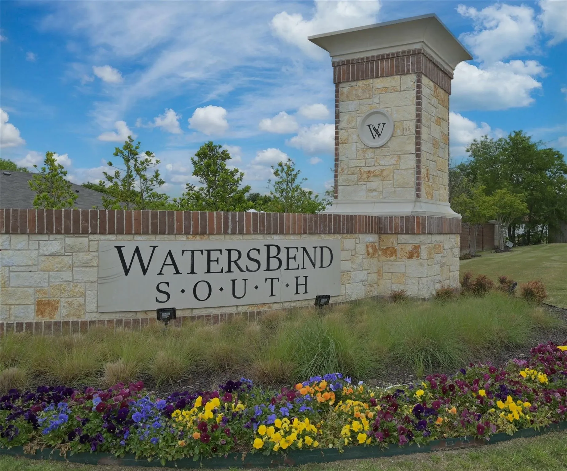 Stone and brick entry monument featuring "WatersBend South" signage