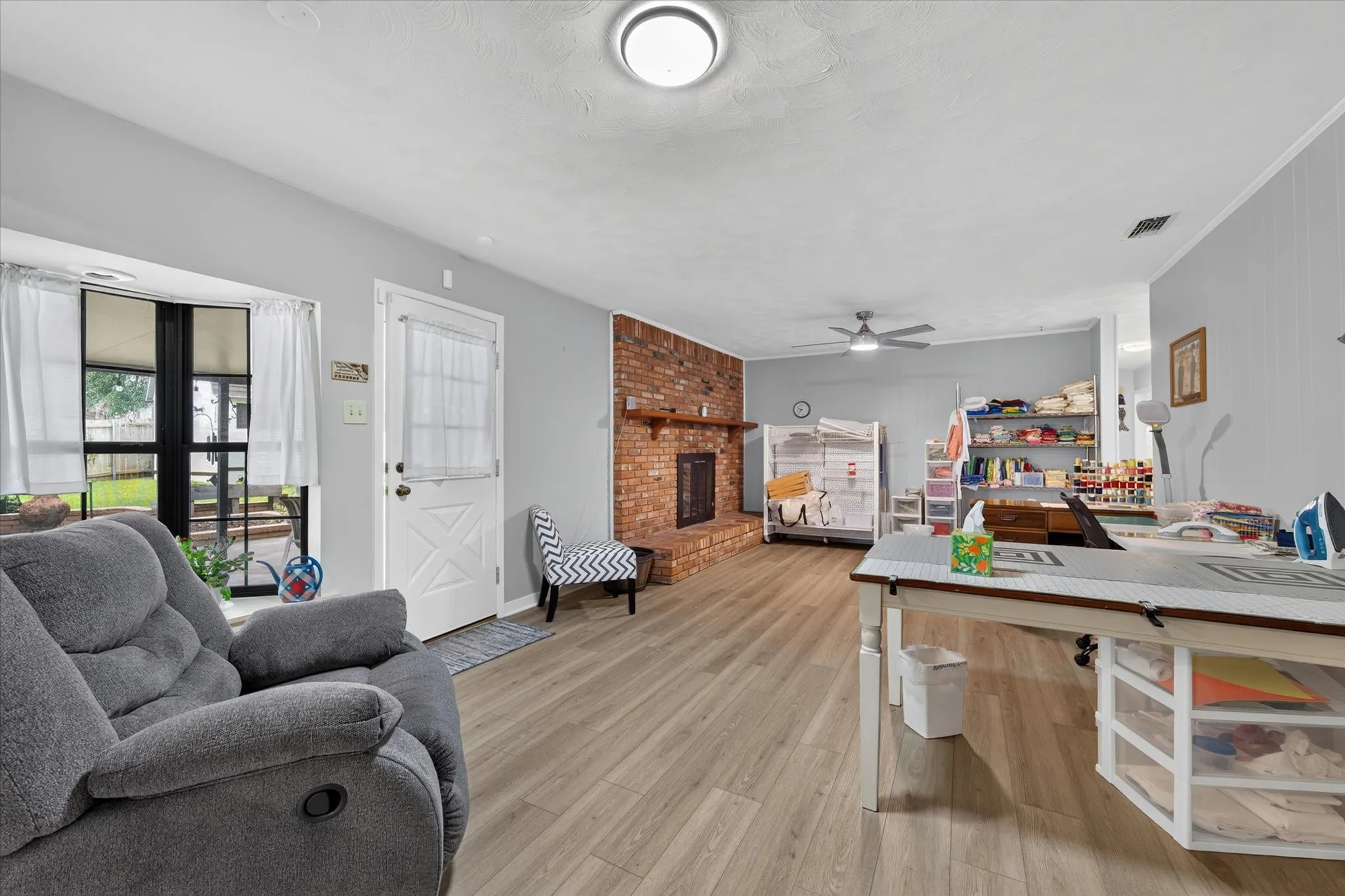 Breakfast nook and family room currently used for a craft space