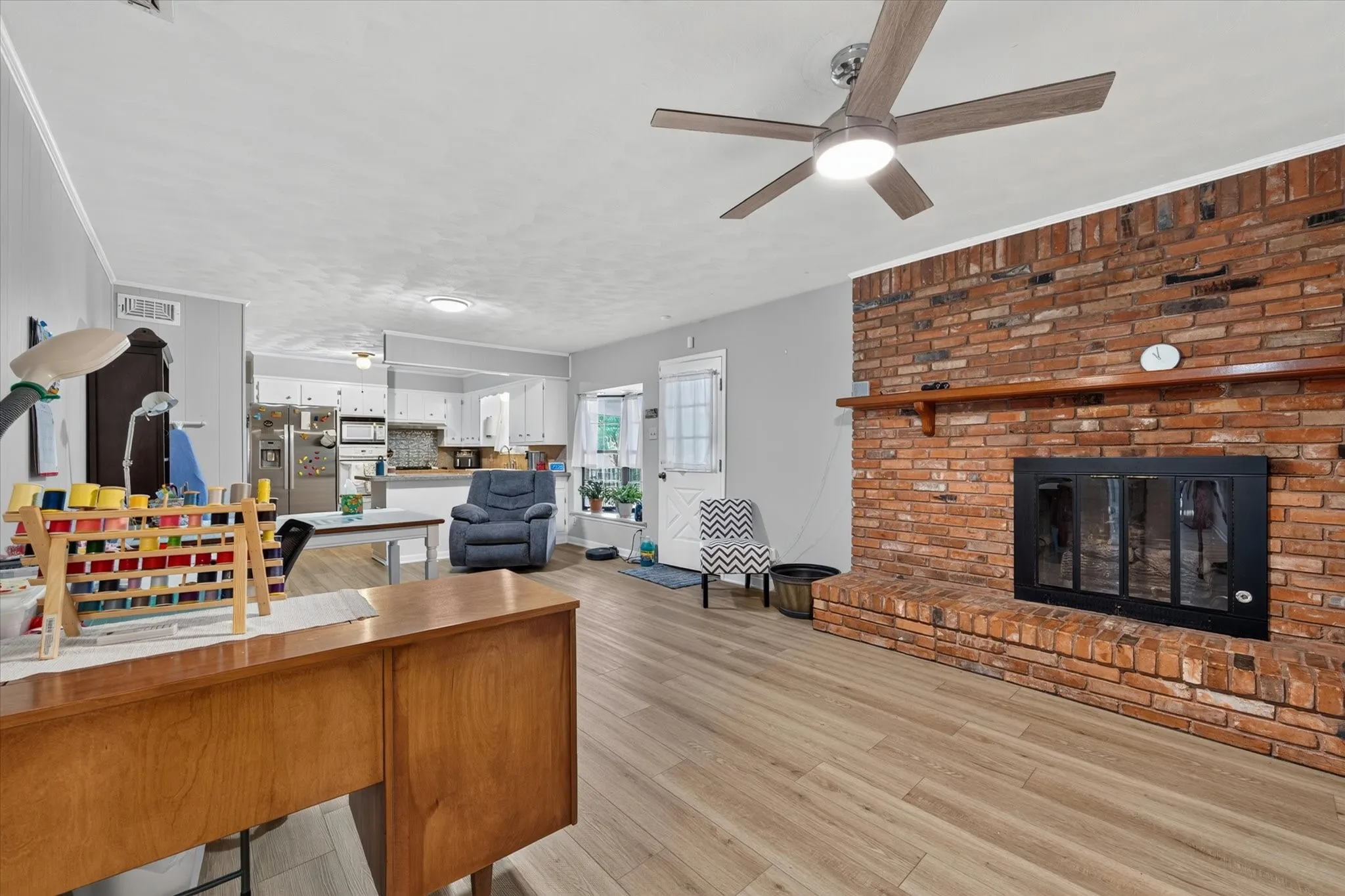 Brick fireplace with a wood-finish mantel and a black-framed insert