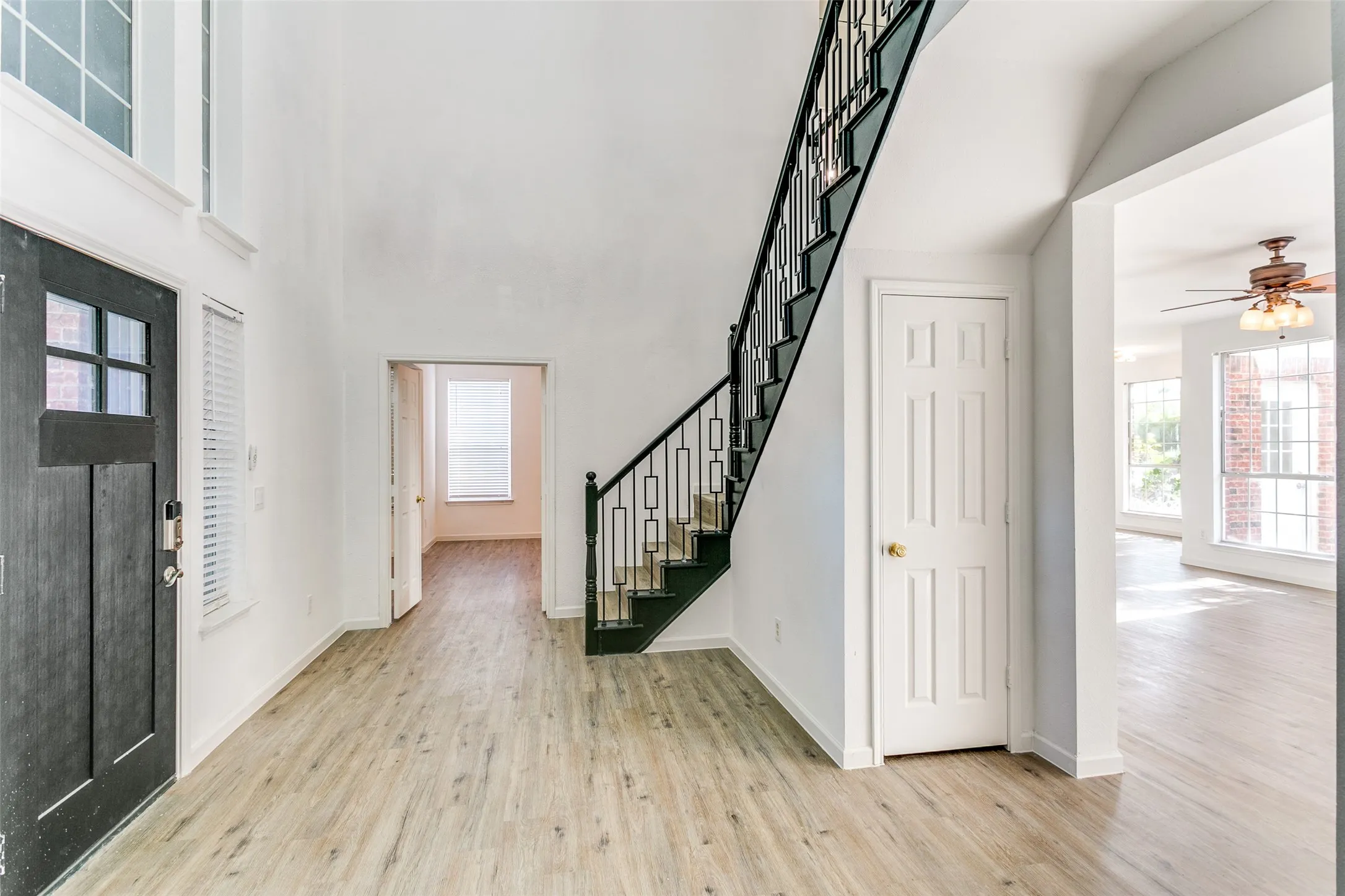 Entryway with light wood-type flooring and ceiling fan