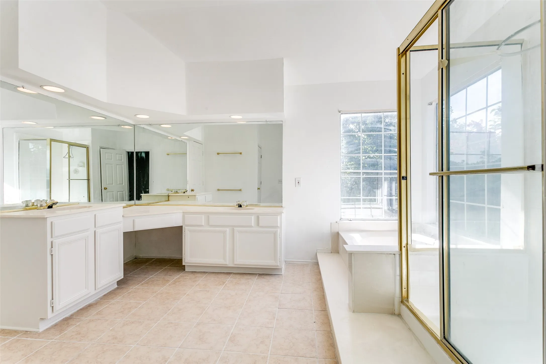Bathroom featuring shower with separate bathtub, vanity, and tile patterned flooring