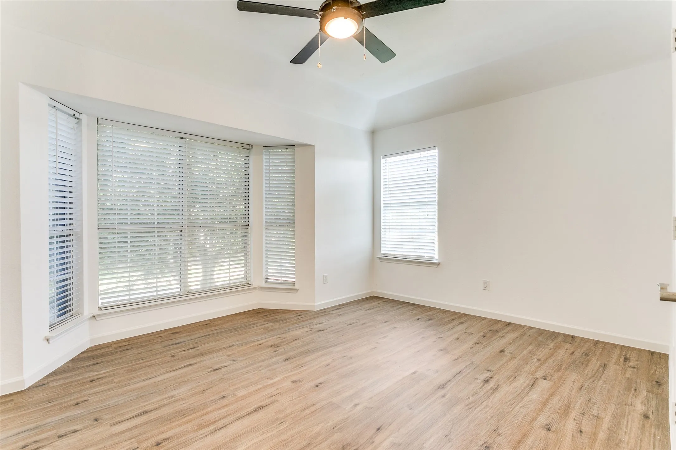 Spare room featuring light wood-type flooring and ceiling fan