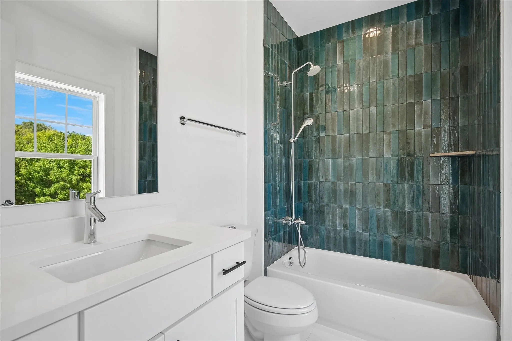 White vanity with stone countertop, integrated rectangular sink, and chrome faucet