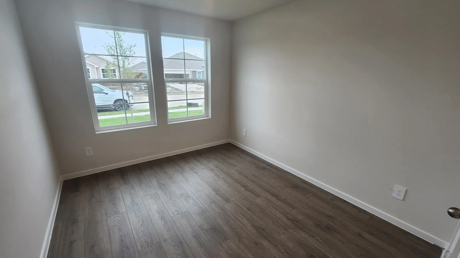 Neutral wall tones with wood-finish flooring