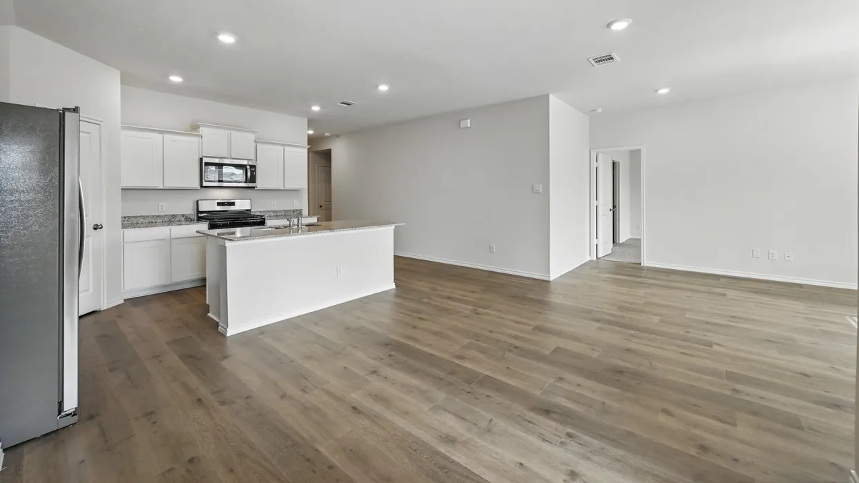Expansive open-concept space featuring wood-finish flooring throughout