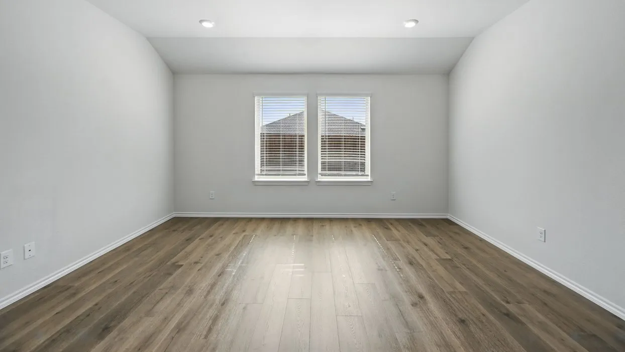 Room featuring wood-finish flooring, two large windows with blinds, recessed lighting, and crisp white walls
