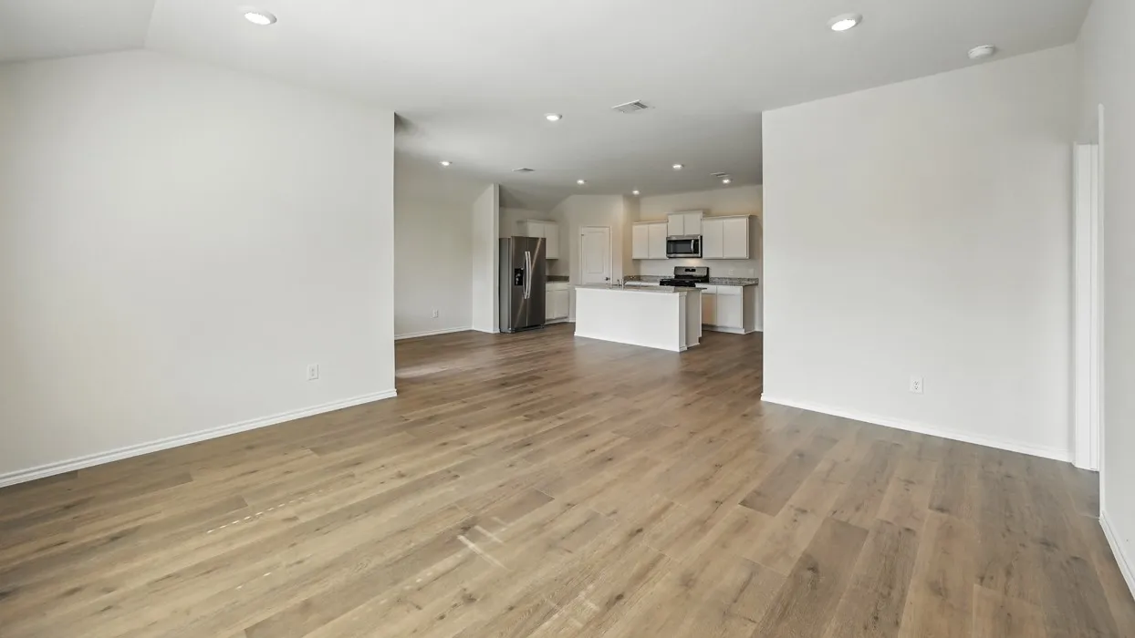 Spacious interior featuring wood-finish flooring, recessed lighting, and a neutral color palette