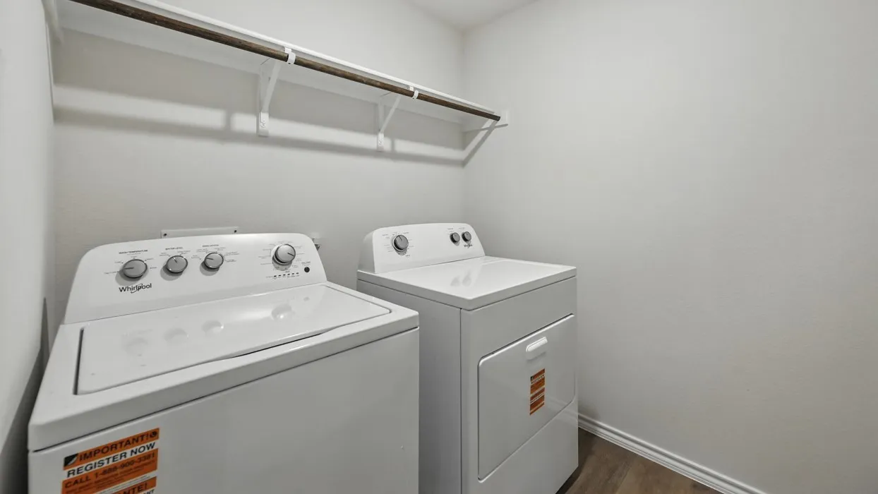Dedicated utility space featuring open shelving and wood-finish flooring