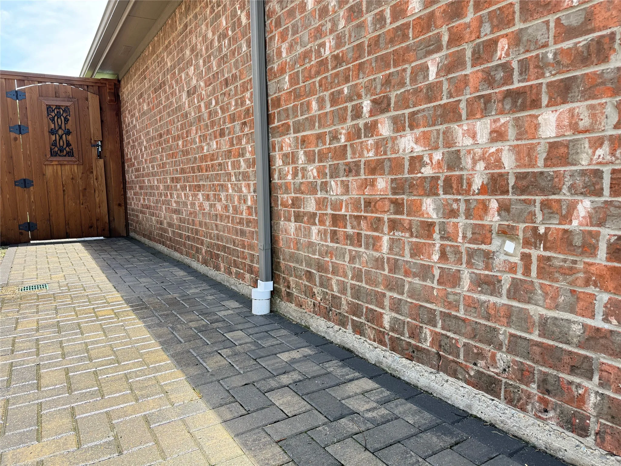 Paver and drainage improvements along the side yard help create a cleaner and more functional exterior space.