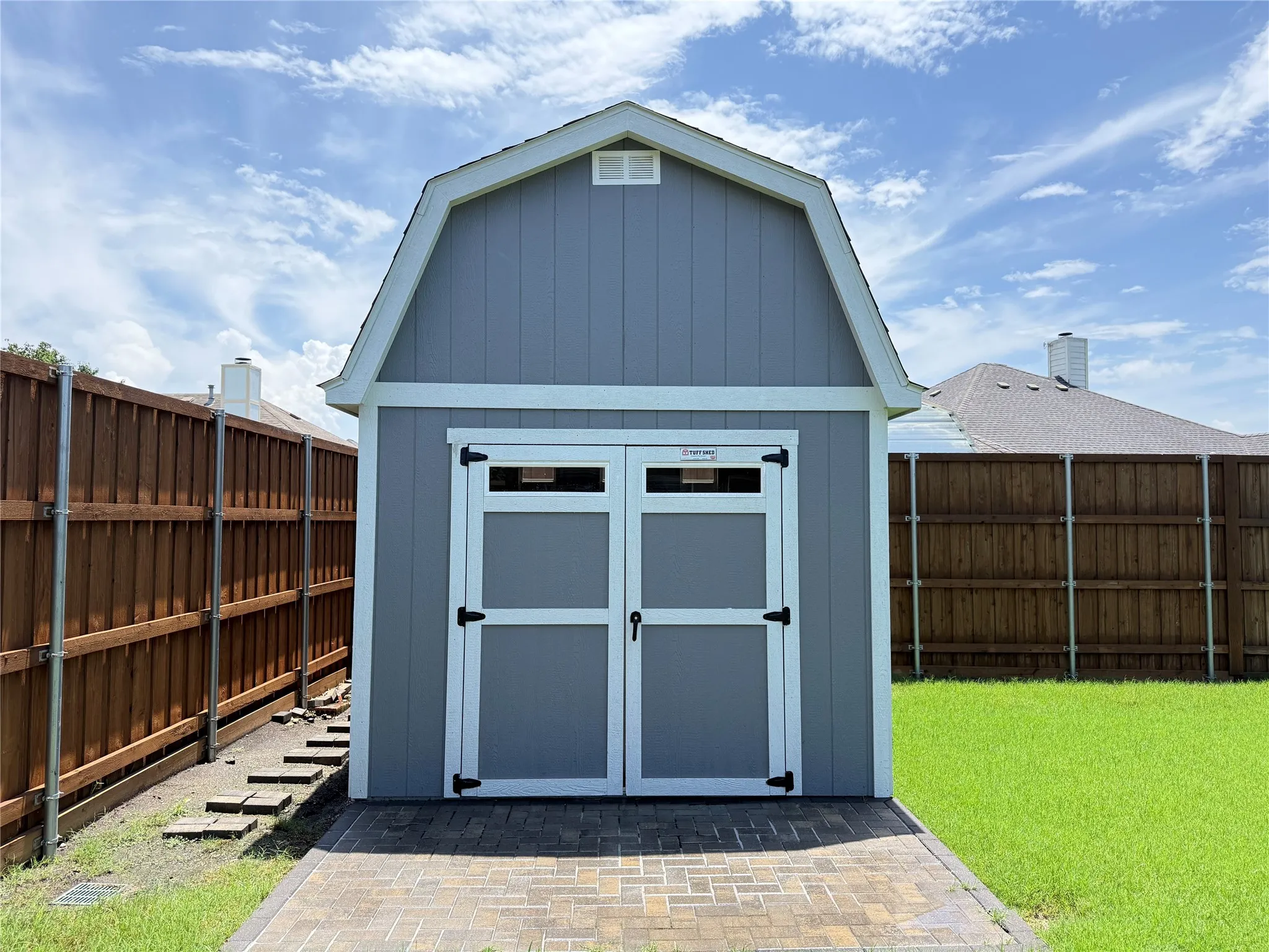 High quality Tuff Shed adds valuable storage, hobby, tool, or workspace flexibility in the fenced backyard.