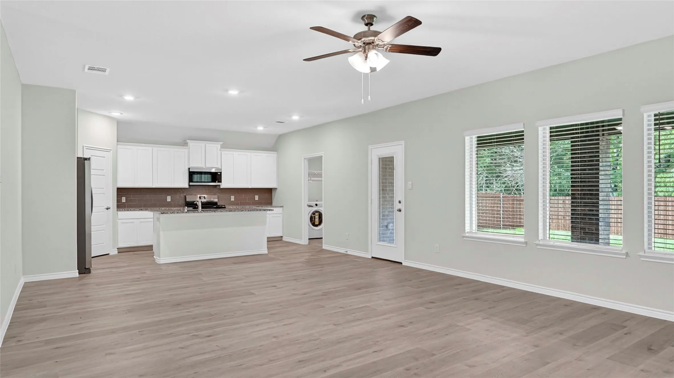 Open-concept living space with wood-finish flooring