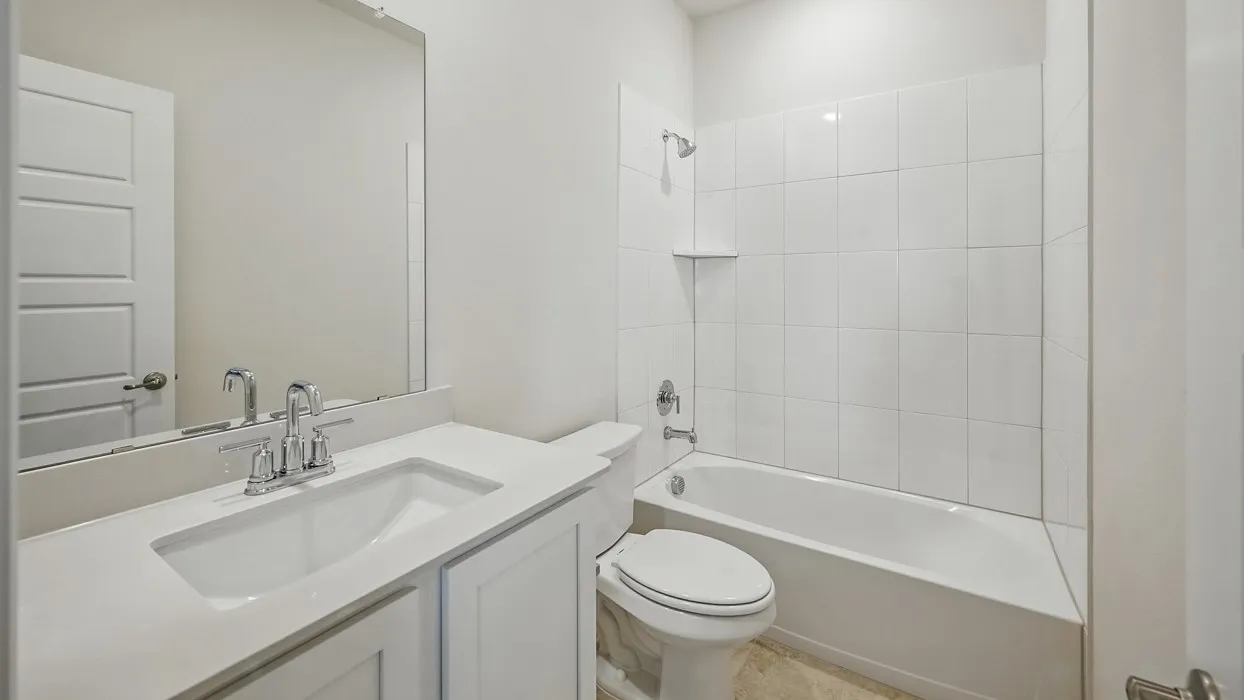 White vanity with an integrated sink, polished chrome faucet, and a large wall-mounted mirror