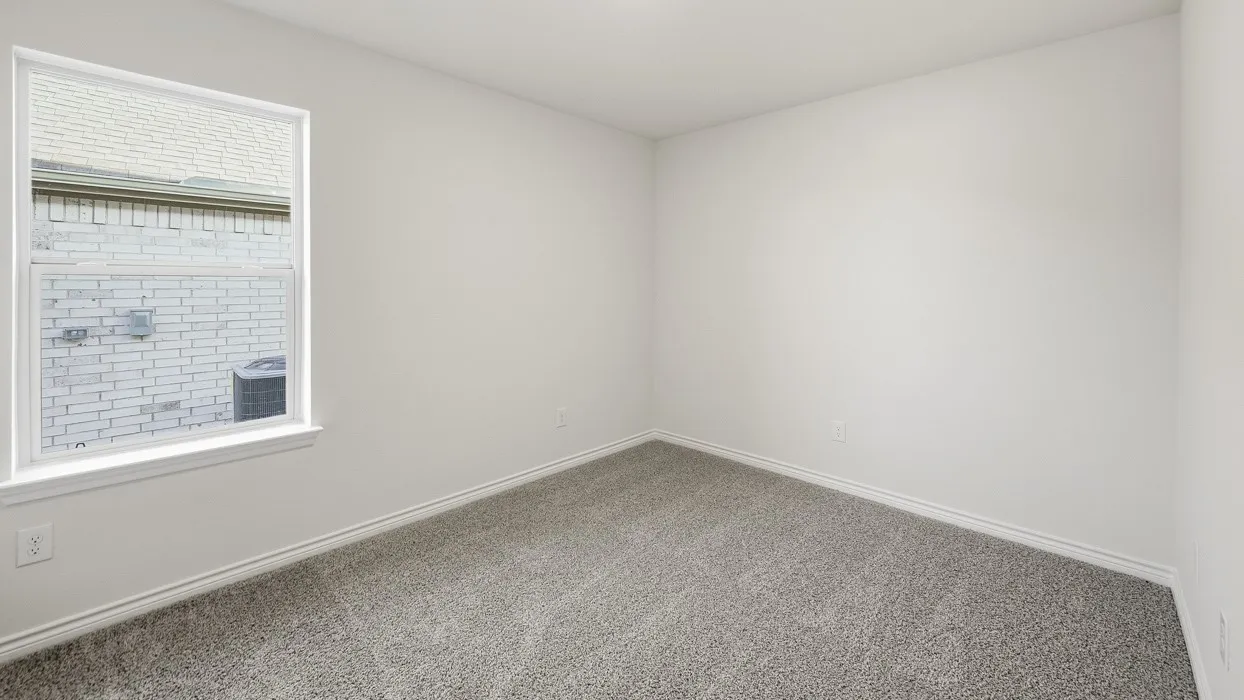 Spacious room featuring neutral carpeting, white walls, a large window, and white trim
