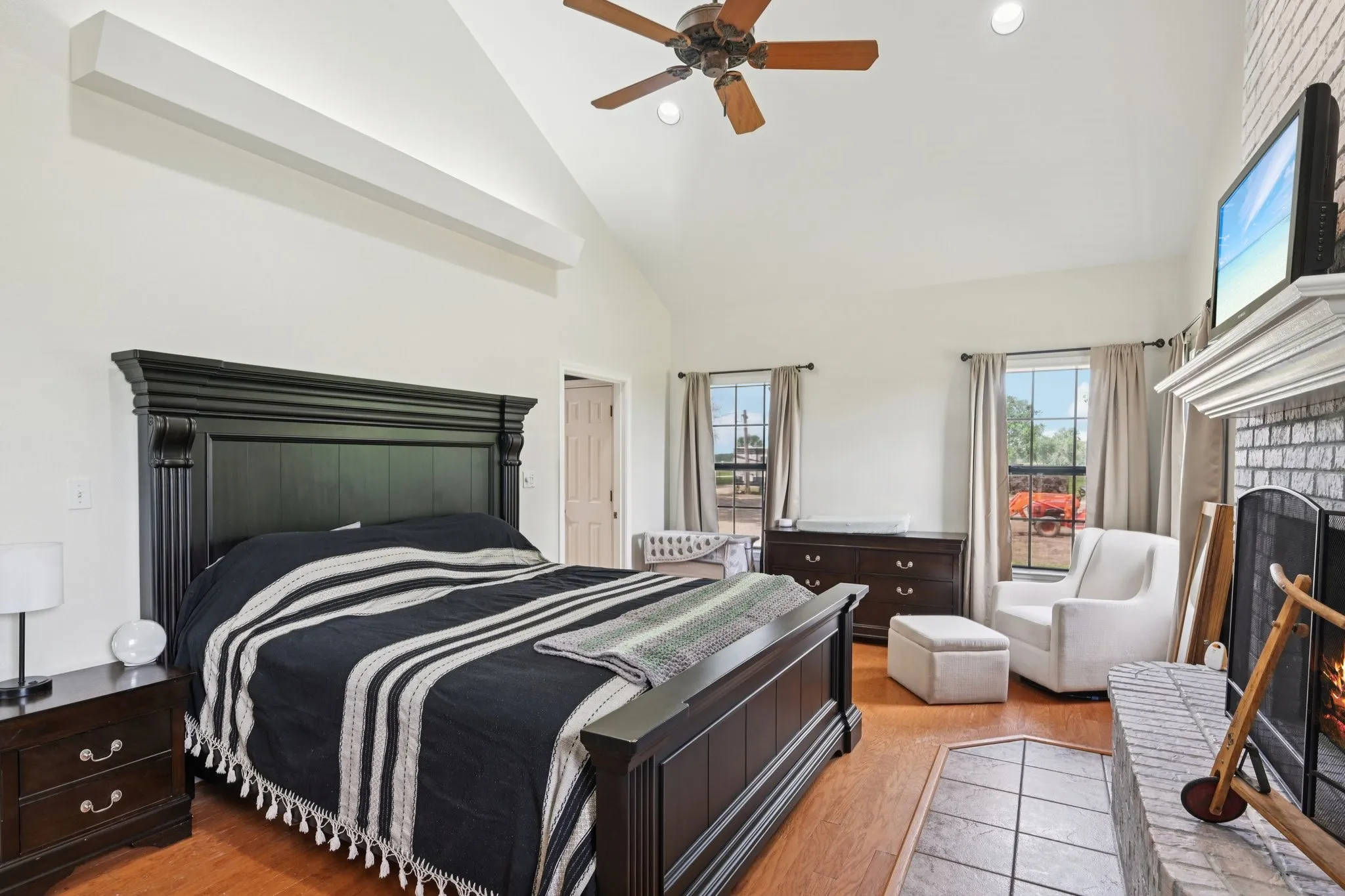 Primary Bedroom with Vaulted Ceiling, Fireplace with floor to Ceiling Tiles, Ceiling Fan