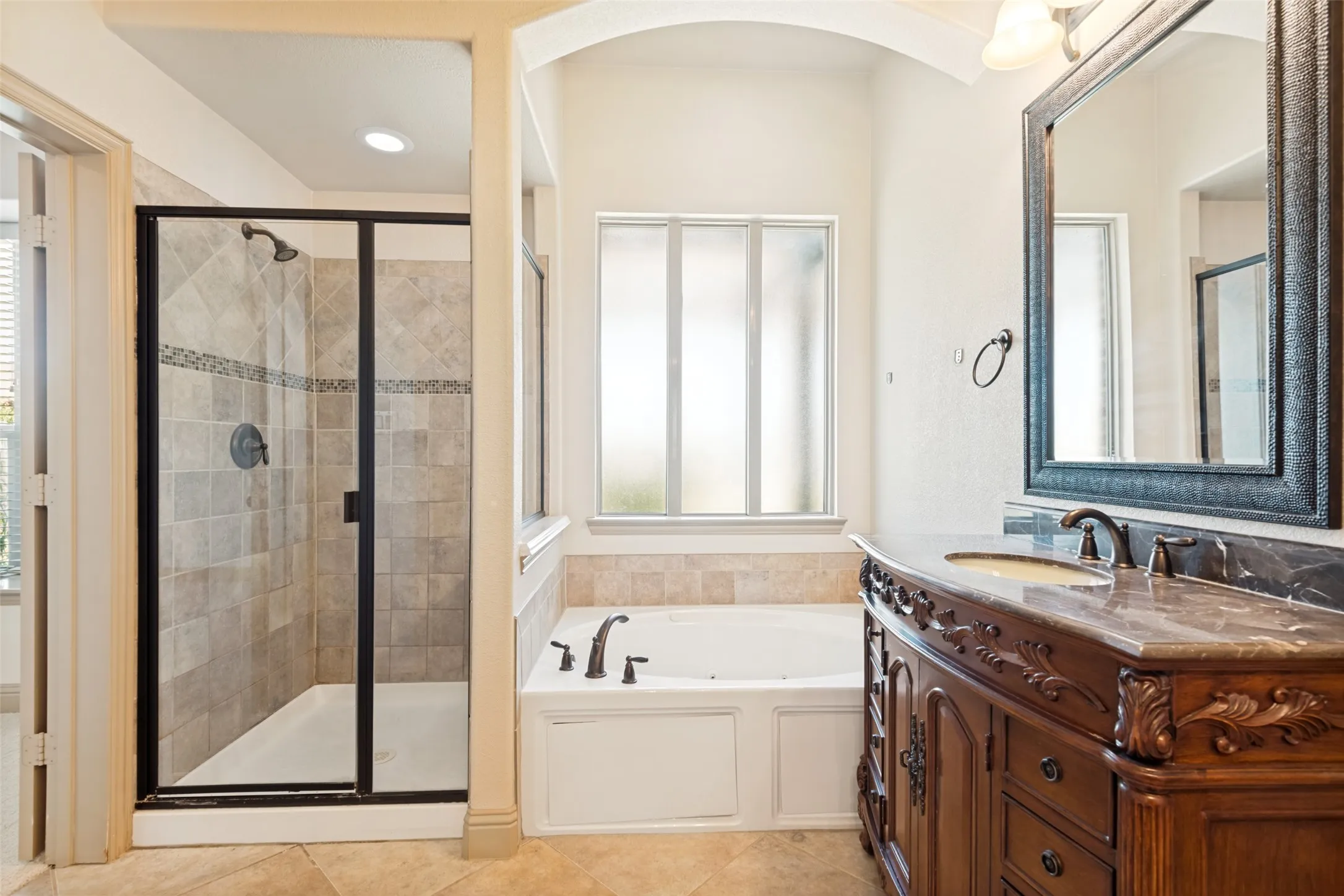 Oversized shower and you can watch TV while resting in the jetted tub.