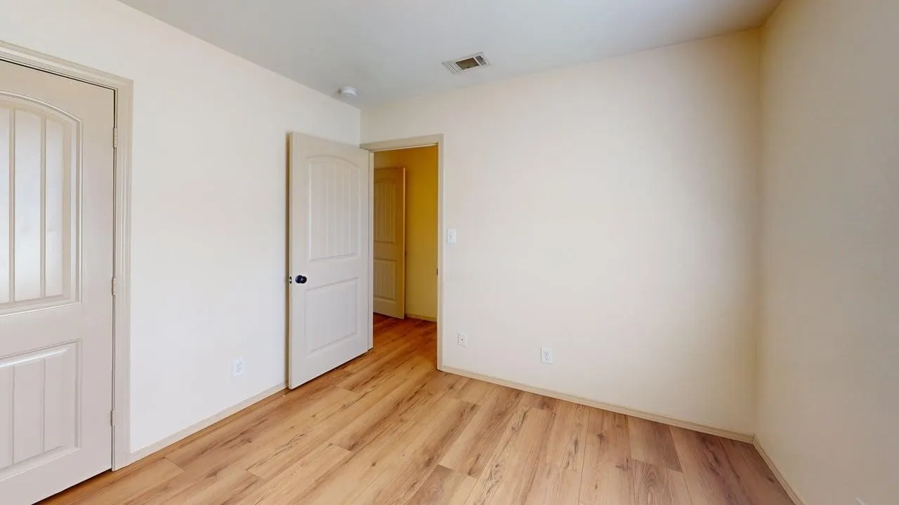 Room featuring wood-finish flooring, neutral wall tones, and recessed ceiling lighting
