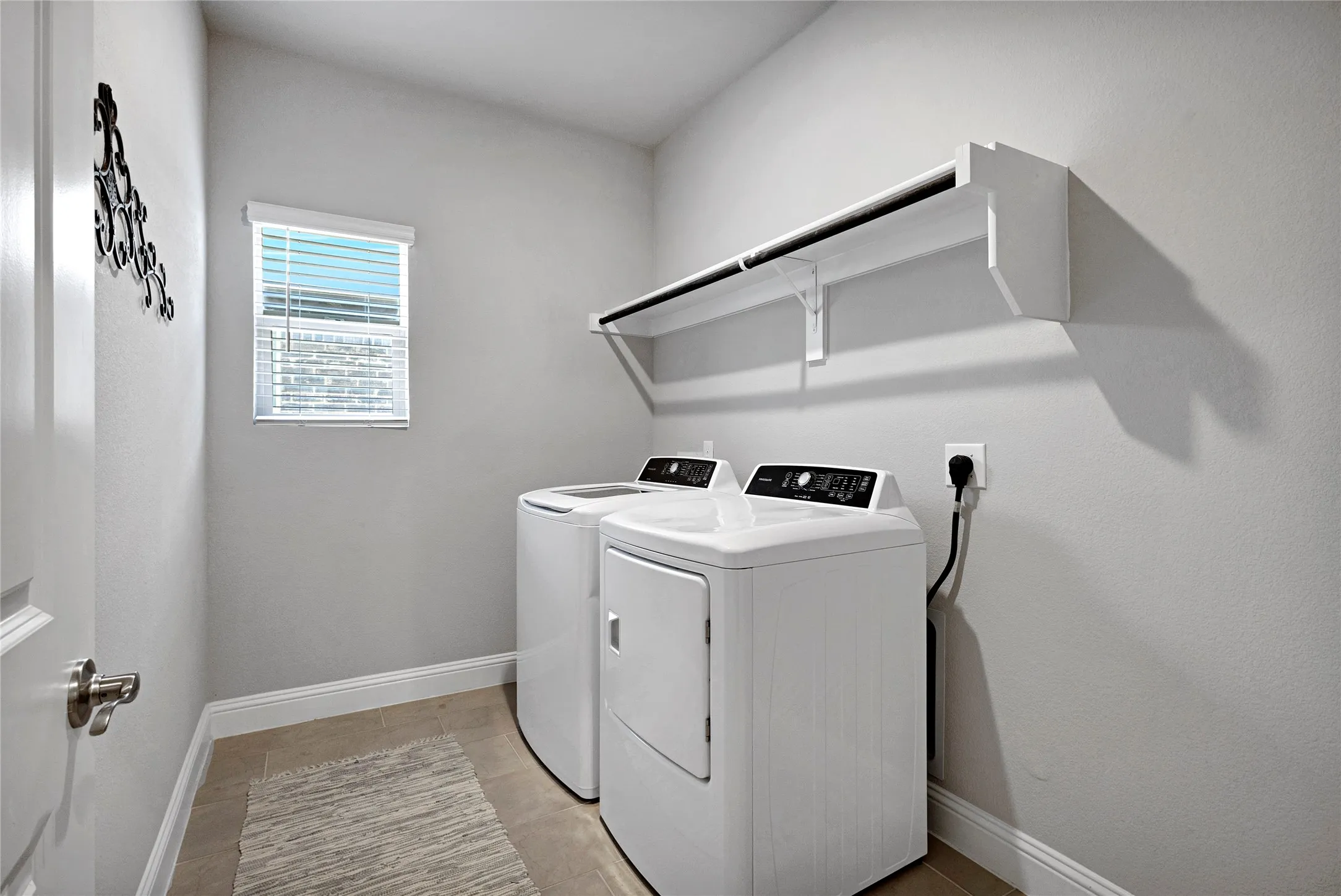 Laundry with full size W/D and storage space.