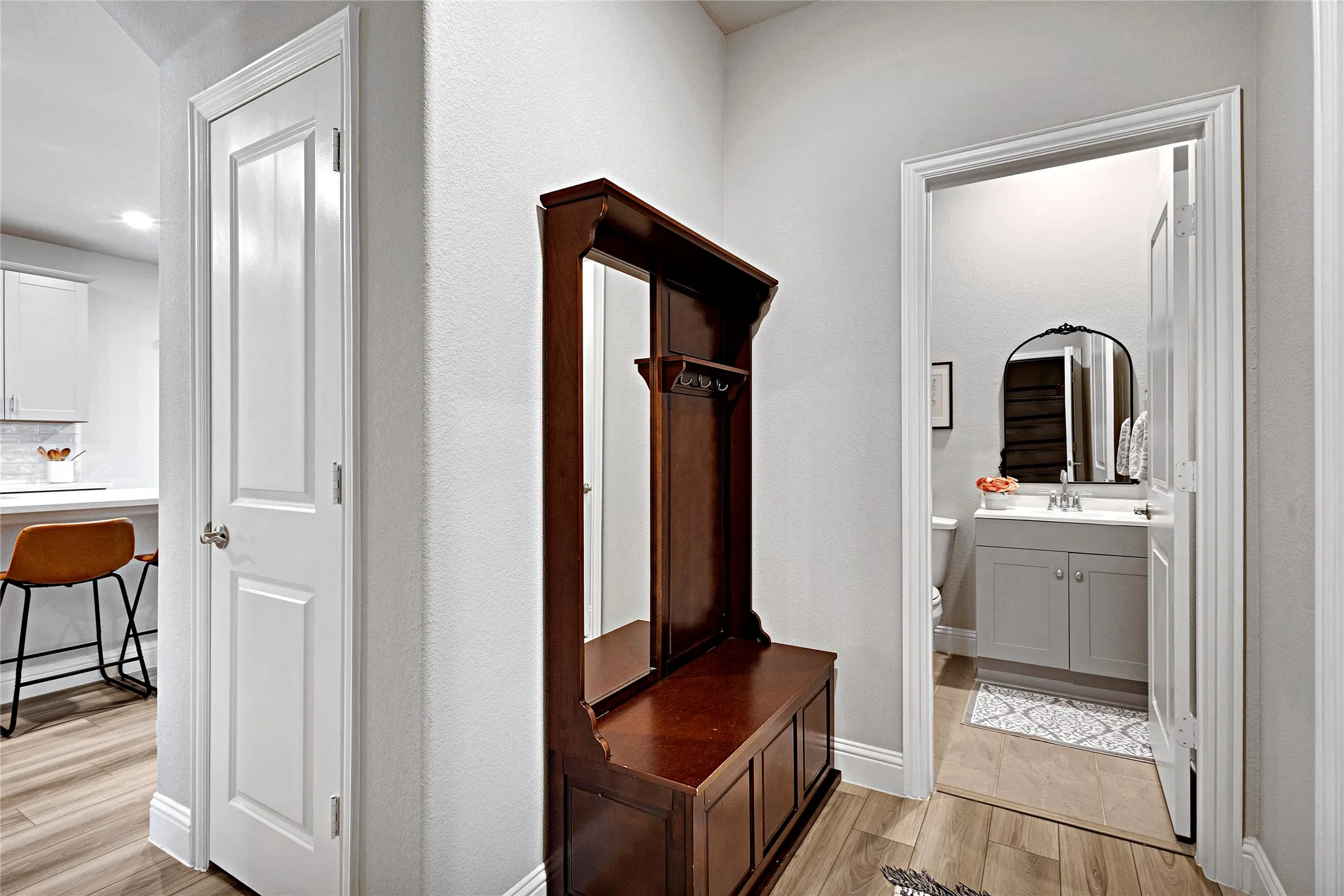 Hallway leading to half bath on the first floor.