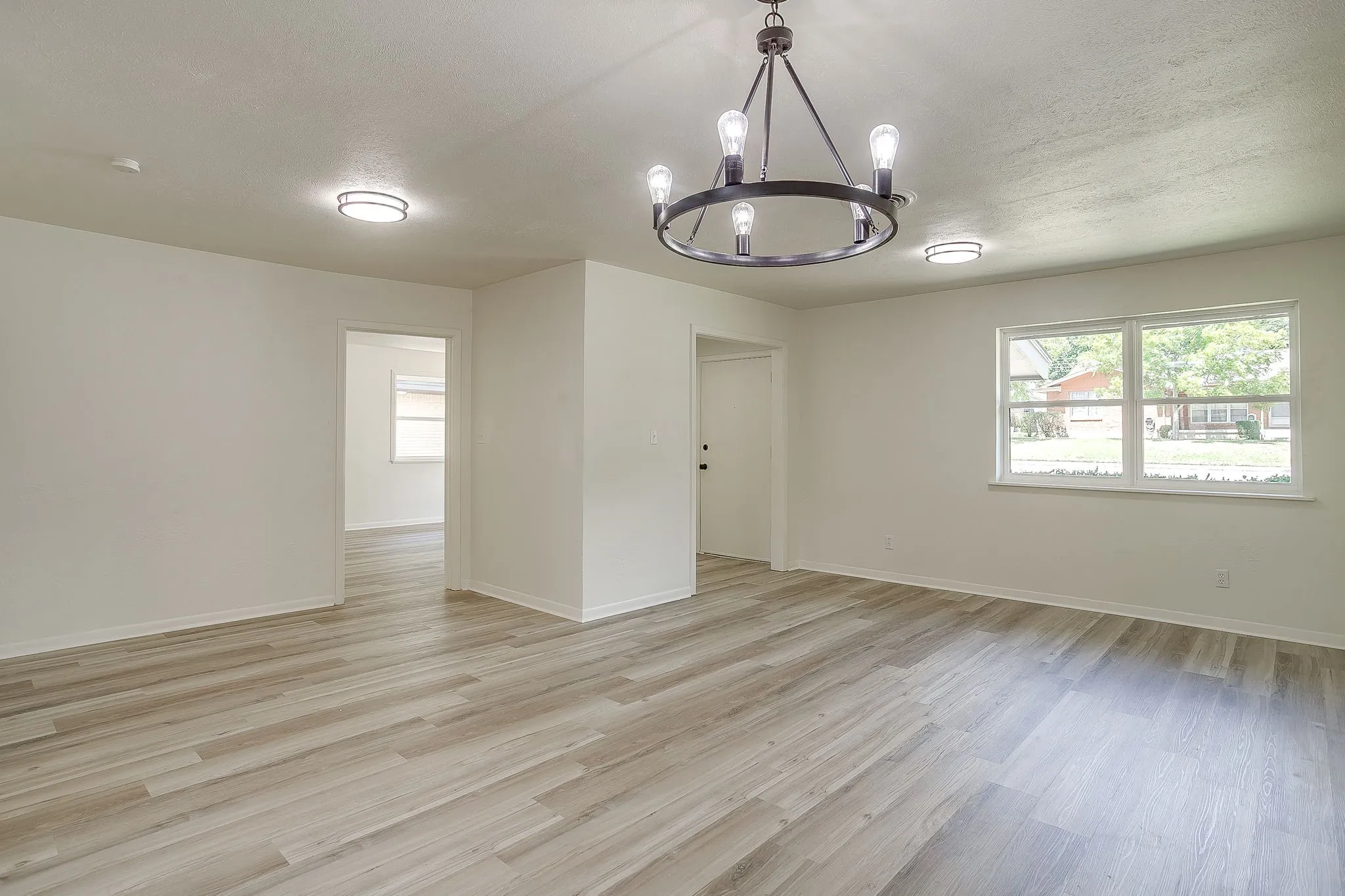 Open-concept living space with light wood-finish flooring