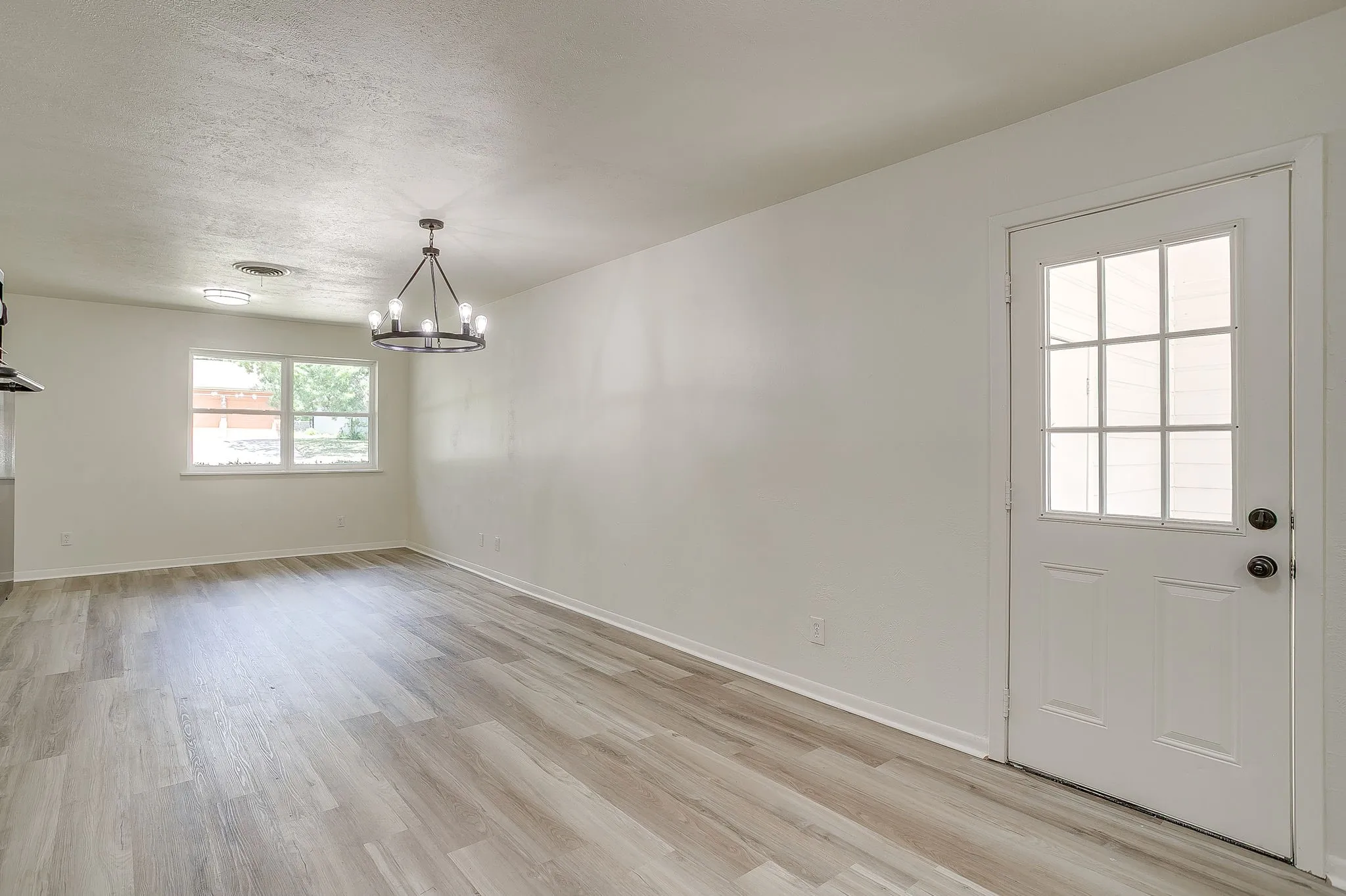 Open-concept living space with light wood-finish flooring